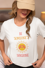 Load image into Gallery viewer, Bring a ray of sunshine into every day with our 'Be Someone's Sunshine' t-shirt. Crafted for those who believe in the power of positivity, this tee stands out with its uplifting message and soft, comfortable fabric, making it more than just a piece of clothing—it's a statement of hope and happiness.