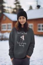 Load image into Gallery viewer, Stay cosy and stylish in our women's sweatshirt featuring the inspiring slogan 'Don't look back, you're not going that way.' Designed for comfort, this fashionable oversized sweatshirt offers a relaxed fit, making it the perfect choice for those seeking a comfortable yet motivational piece.