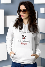 Load image into Gallery viewer, Stay stylish and empowered with our fashionable oversized women's hoodie featuring the inspiring message 'Keep your heels, head, and standards high.' This modern, relaxed-fit hoodie combines comfort with a bold statement, perfect for adding a chic touch to your everyday wardrobe.