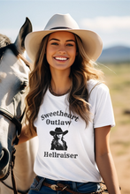 Load image into Gallery viewer, Woman wearing a white t-shirt with a graphic and text, standing next to a horse in an outdoor setting.