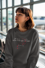 Load image into Gallery viewer, Stay cosy in our women's relaxed fit sweatshirt featuring the uplifting message 'La Vie en Rose.' This comfortable, oversized sweatshirt combines modern style with a relaxed fit, perfect for adding a touch of positivity to your wardrobe. Ideal for those who love stylish, laid-back fashion.