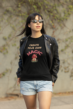 Load image into Gallery viewer, Embrace eco-friendly fashion with our women's organic cotton t-shirt featuring the empowering message 'Create Your Own Magic.' This premium sustainable tee offers style and comfort, perfect for those who value quality and the environment. Elevate your wardrobe with this must-have inspirational piece.