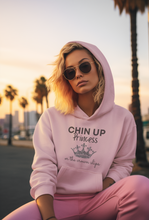 Load image into Gallery viewer, Explore our chic women's pocket hoodie featuring the slogan 'Chin Up Princess, or the Crown Slips.' Perfect for casual street style, this high-quality hoodie combines comfort with premium women's hoodie styles. Elevate your wardrobe with this must-have, empowering piece.