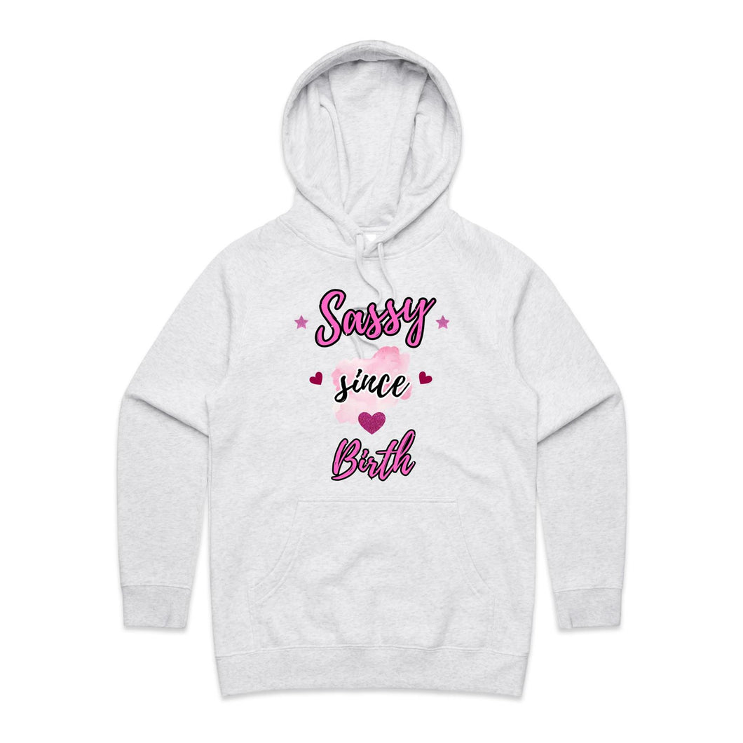 Own your sass with the ‘Sassy Since Birth’ pocket hoodie – featuring a bold graphic design and cosy cotton blend. Perfect for comfort with attitude.